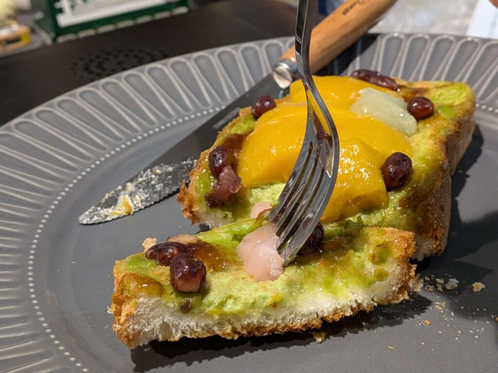 フライパンで焼いたオープンサンドの断面接写。底面はカリッと香ばしく、上には鮮やかな抹茶クリームがたっぷりと塗られている。